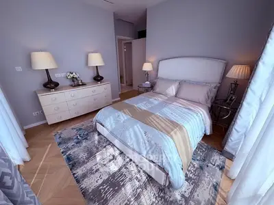 Elegant bedroom with stylish decor and ample natural light, featuring a cozy bed and modern furnishings.