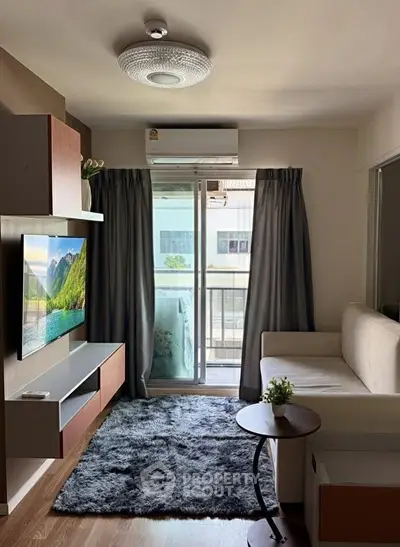 Modern living room with balcony access, featuring sleek furniture and a cozy atmosphere.