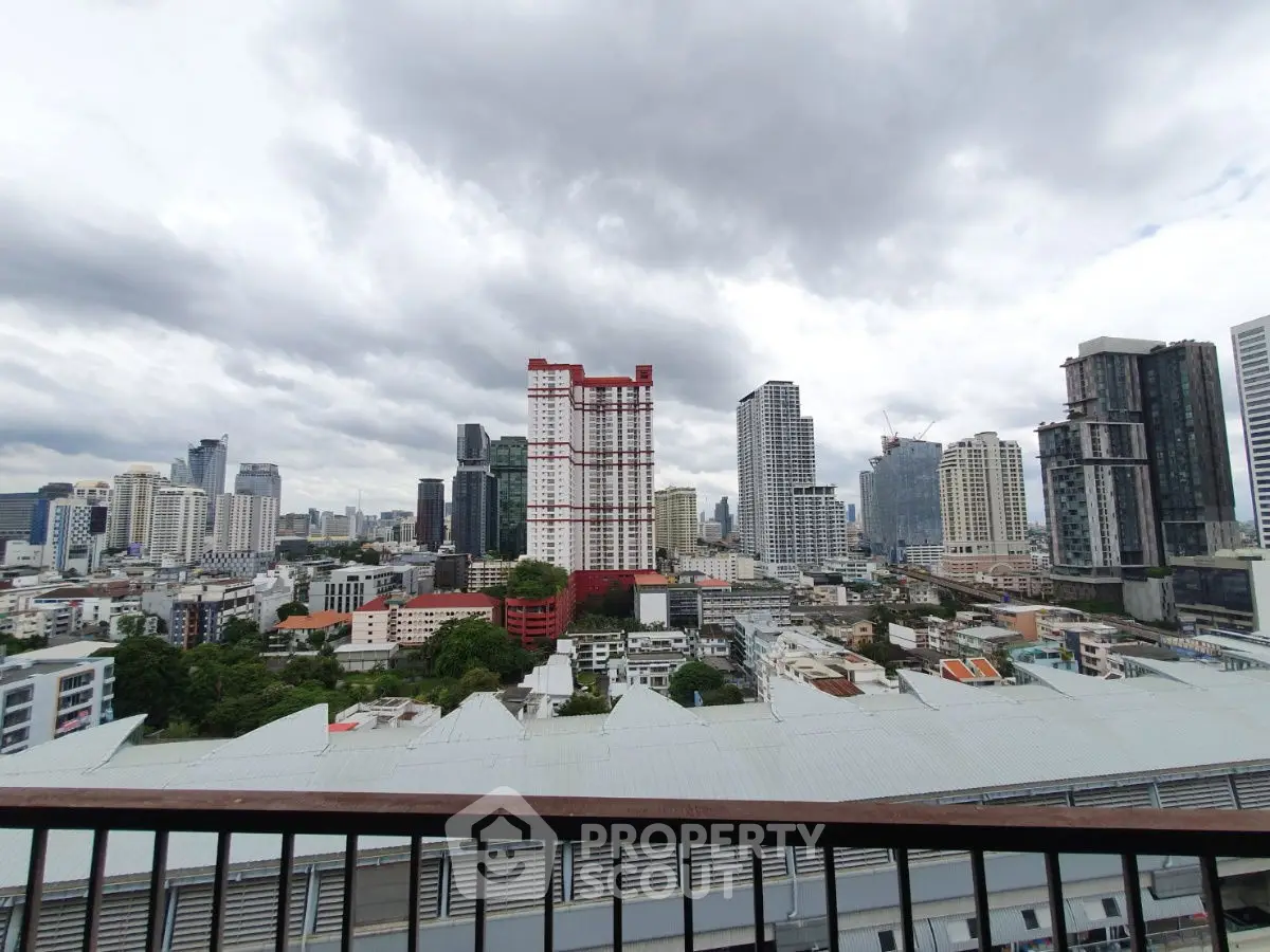 Stunning cityscape view from a high-rise balcony overlooking urban skyline.
