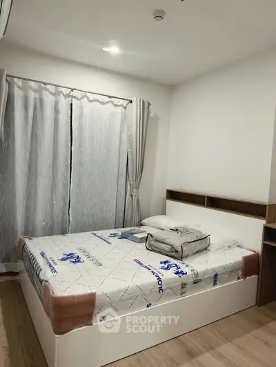 Modern bedroom with stylish bed and elegant curtains in a cozy apartment.