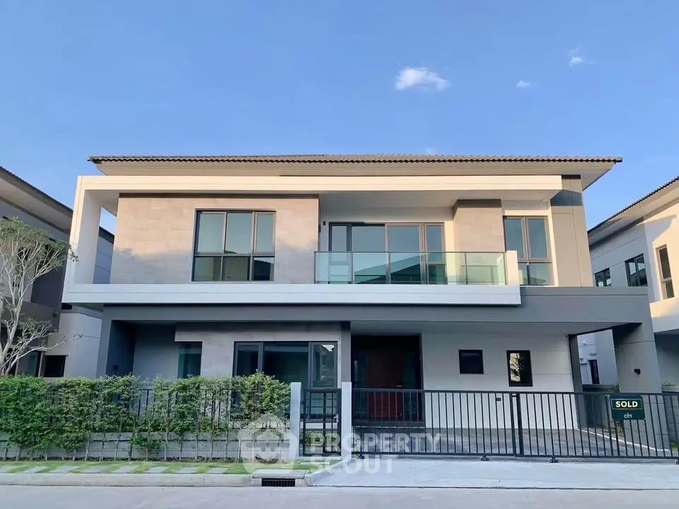 Modern two-story house with sleek design and spacious balcony in a serene neighborhood.