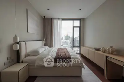 Luxurious bedroom with city view, elegant decor, and natural light.