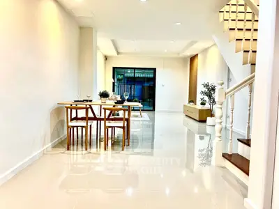 Spacious modern living room with elegant dining area and staircase