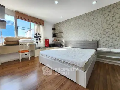 Spacious bedroom with modern decor and natural light