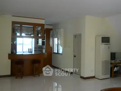 Spacious living room with bar area and natural light