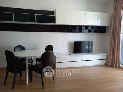 Modern living room with sleek furniture and wall-mounted storage