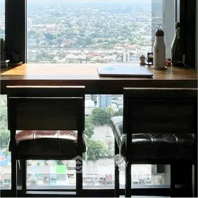 Stunning high-rise apartment with panoramic city view from a cozy study area.