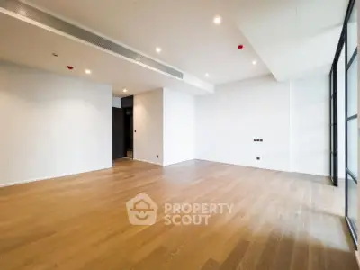 Spacious modern living room with wooden flooring and large windows