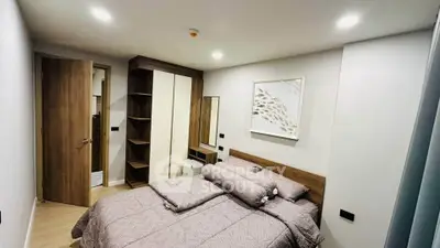 Modern bedroom with stylish decor and ample storage in a cozy apartment.