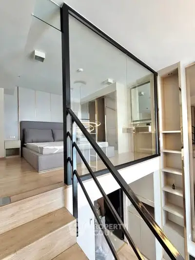 Modern loft bedroom with glass wall and wooden flooring
