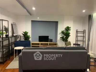 Modern living room with stylish furniture and indoor plants, perfect for relaxation and entertainment.