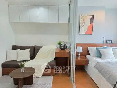 Modern studio apartment with cozy living area and stylish bedroom