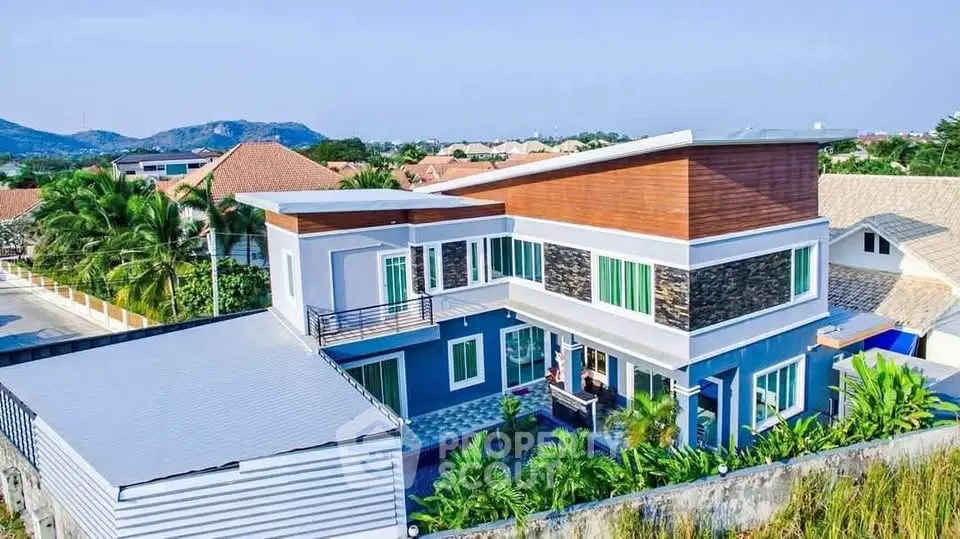 Stunning modern two-story house with lush garden and mountain views in a serene neighborhood.