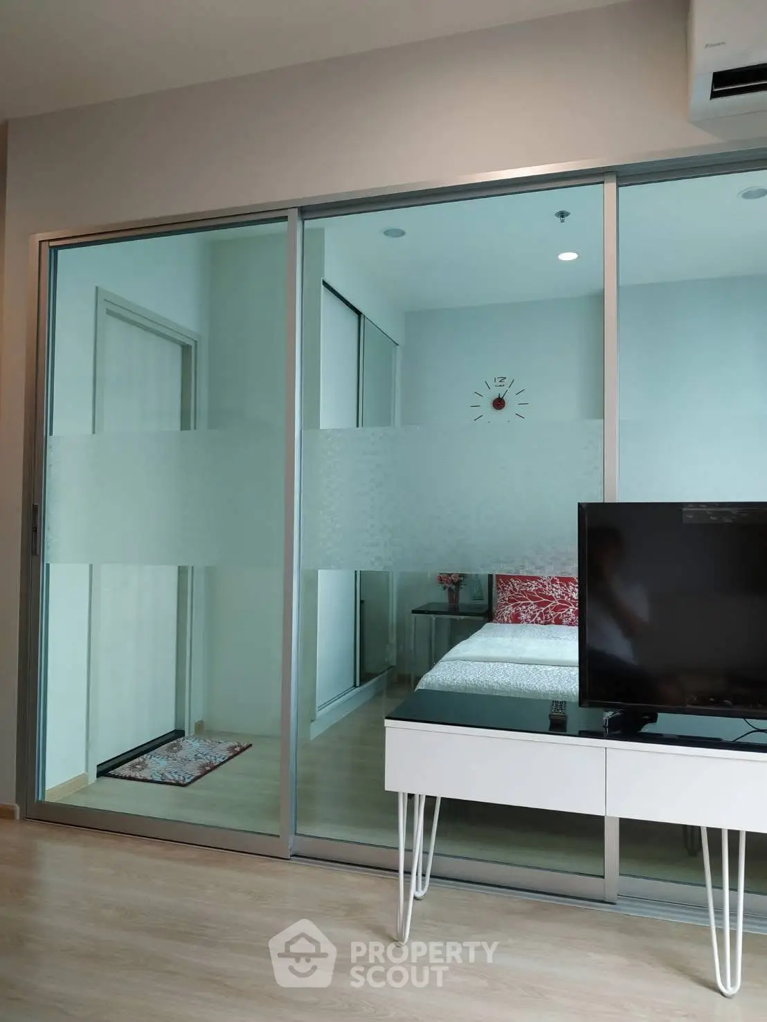 Modern bedroom with glass sliding doors and stylish decor