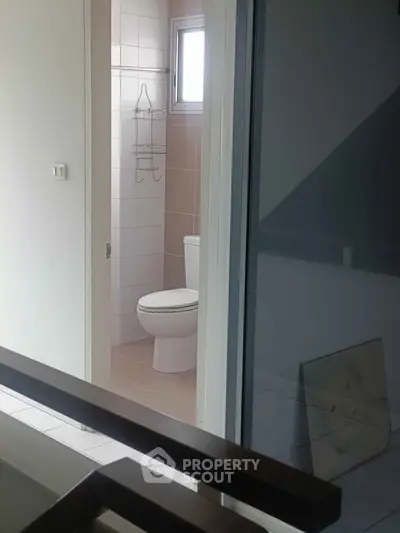 Modern bathroom with sleek design and natural light in a contemporary home.