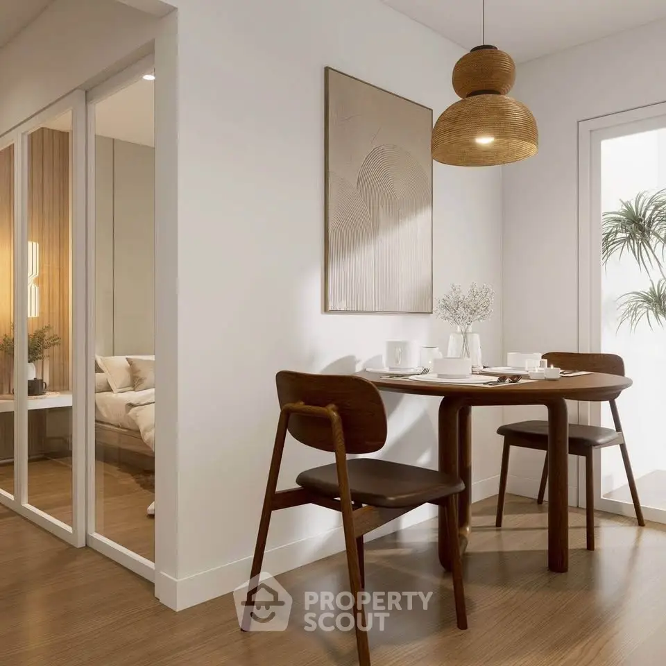 Modern dining area with wooden table and chairs, stylish pendant light, and cozy bedroom view.