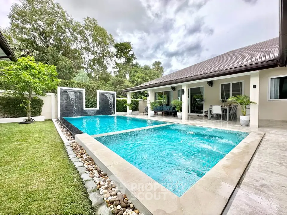 Luxurious modern home with stunning pool and lush garden, perfect for relaxation and entertaining.