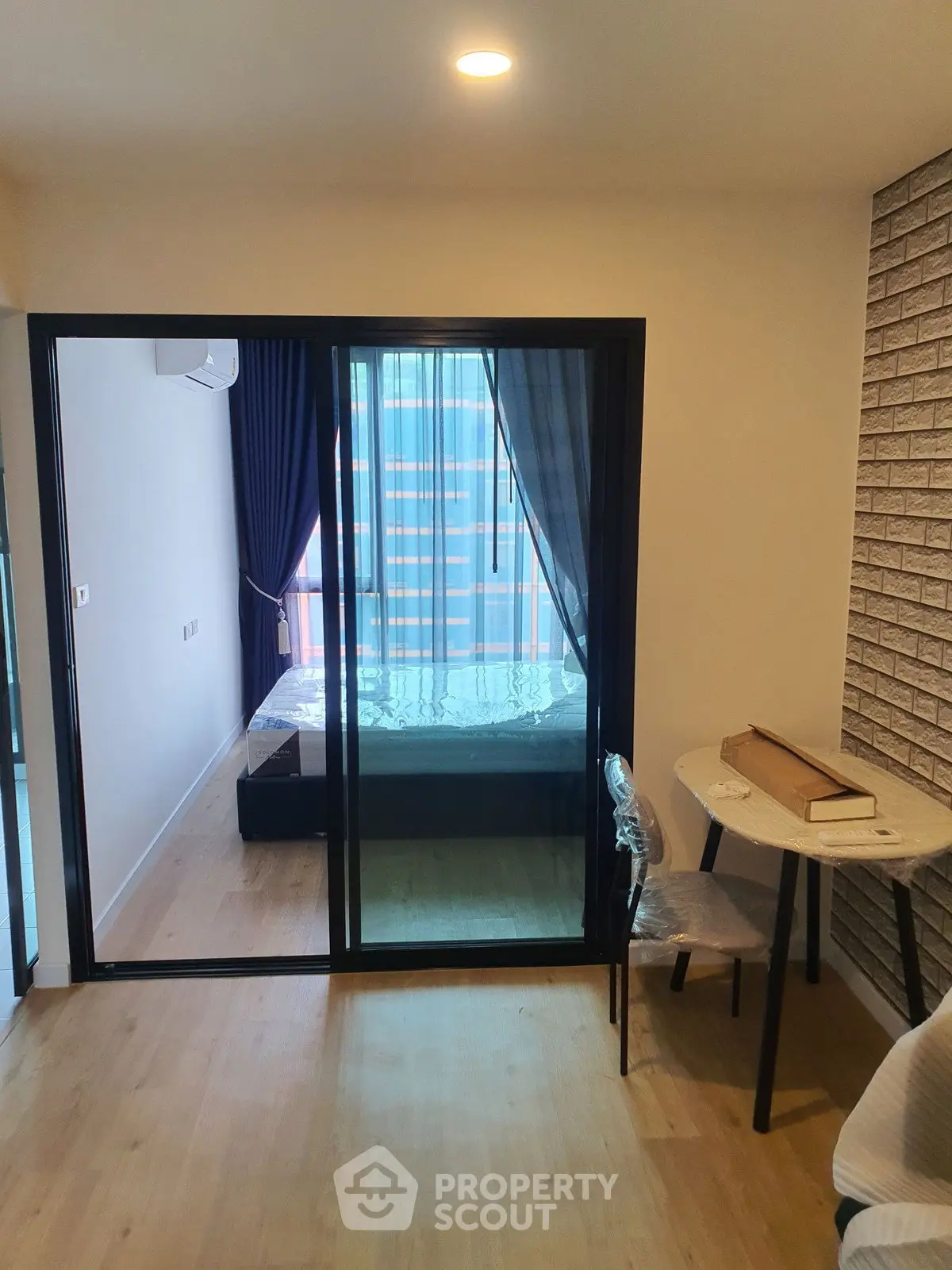 Modern apartment with glass-walled bedroom and stylish decor