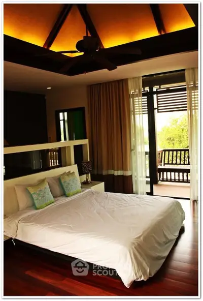 Luxurious bedroom with elegant decor and balcony access, featuring hardwood floors and ambient lighting.