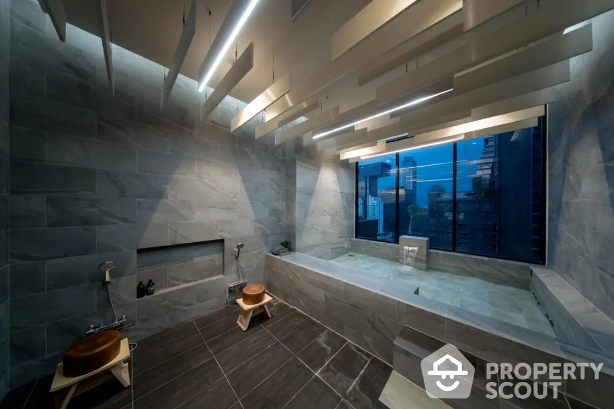 Luxurious modern bathroom with city view and elegant stone finishes