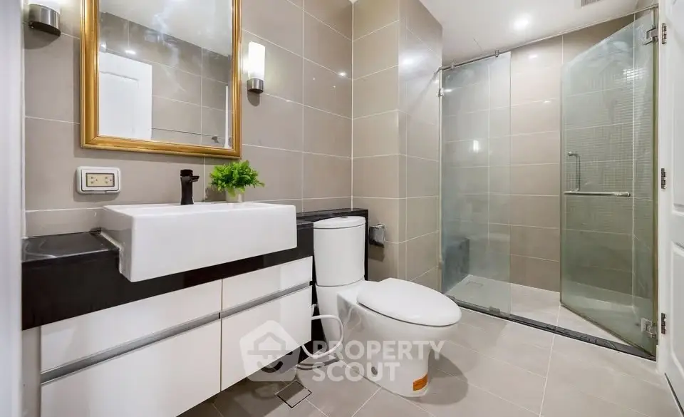 Modern bathroom with sleek fixtures and glass shower enclosure