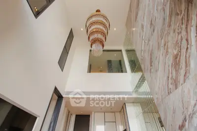 Luxurious modern interior with high ceiling and elegant chandelier