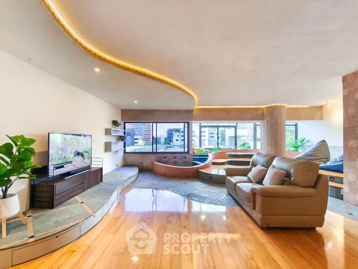 Spacious living room with modern design and city view, featuring cozy seating and natural light.