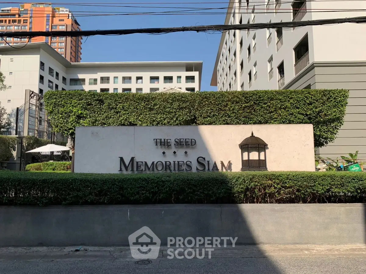 Modern condominium exterior with lush greenery at The Seed Memories Siam.