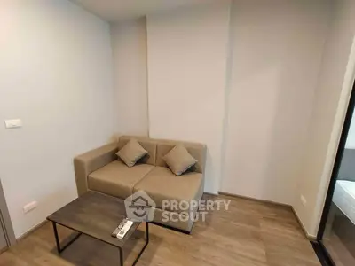 Cozy living room with modern sofa and sleek coffee table in a minimalist design.