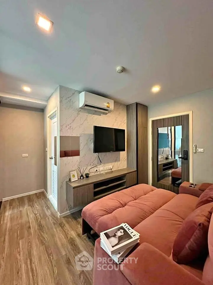 Modern living room with stylish decor and cozy seating in a contemporary apartment.