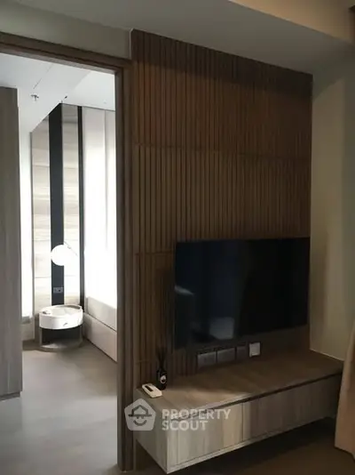 Modern living room with sleek wooden paneling and wall-mounted TV