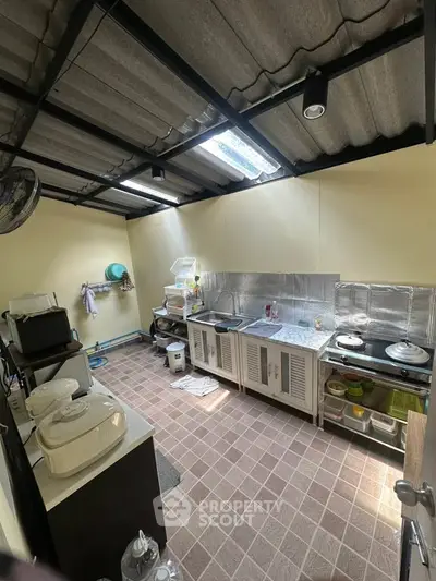 Spacious kitchen with modern appliances and ample storage in a well-lit area.