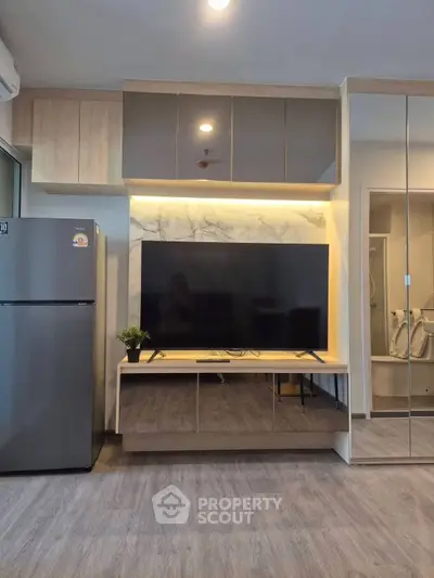 Modern living room with sleek TV unit and stylish decor, featuring a spacious layout and contemporary design.