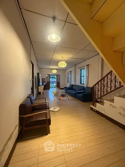 Spacious living room with cozy seating and modern lighting