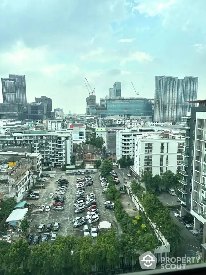 Stunning cityscape view from high-rise building with ample parking space and modern architecture.