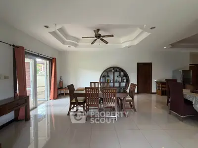 Spacious dining area with elegant ceiling design and natural light