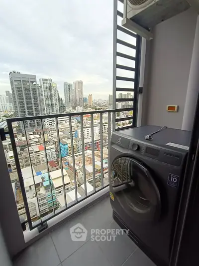 High-rise apartment balcony with washing machine and city skyline view