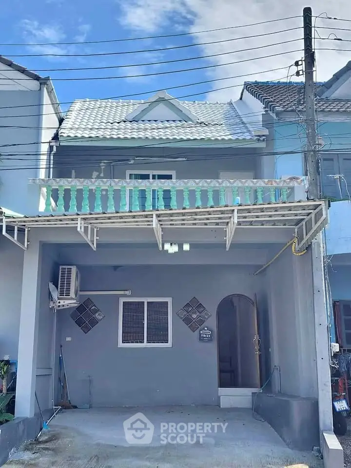 Charming two-story townhouse with balcony and modern exterior design.