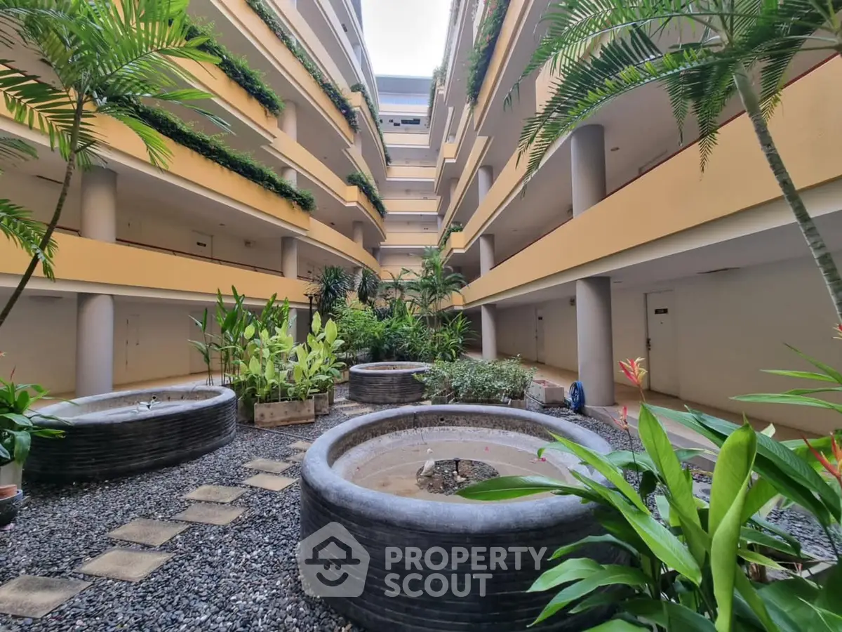 Stunning multi-level building atrium with lush greenery and modern design.