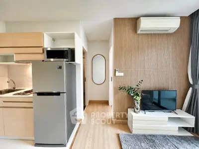 Modern apartment interior with sleek kitchen and cozy living area featuring air conditioning and stylish decor.