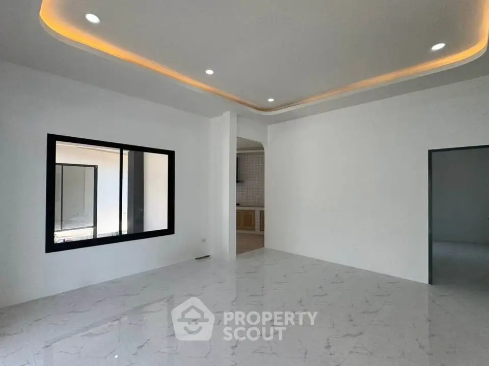 Spacious modern living room with sleek marble flooring and recessed lighting