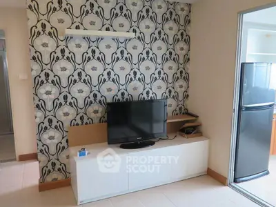 Stylish living room with modern TV setup and elegant wallpaper design