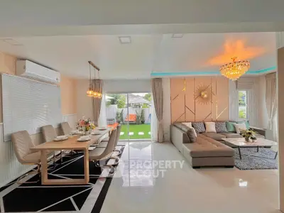 Luxurious open-plan living room with elegant dining area and garden view.