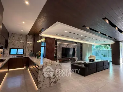 Luxurious open-plan living room with marble accents and modern kitchen