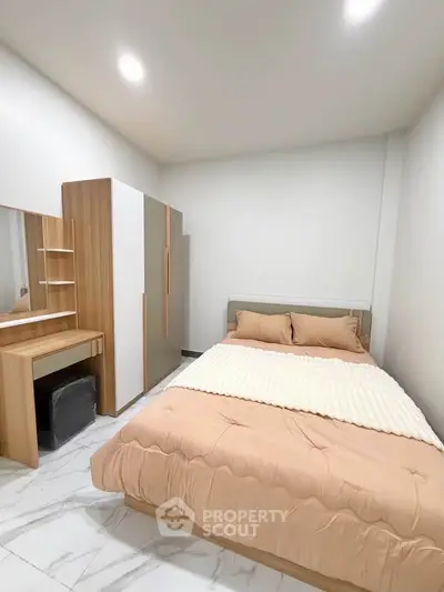 Cozy bedroom with modern furniture and soft lighting, perfect for relaxation.