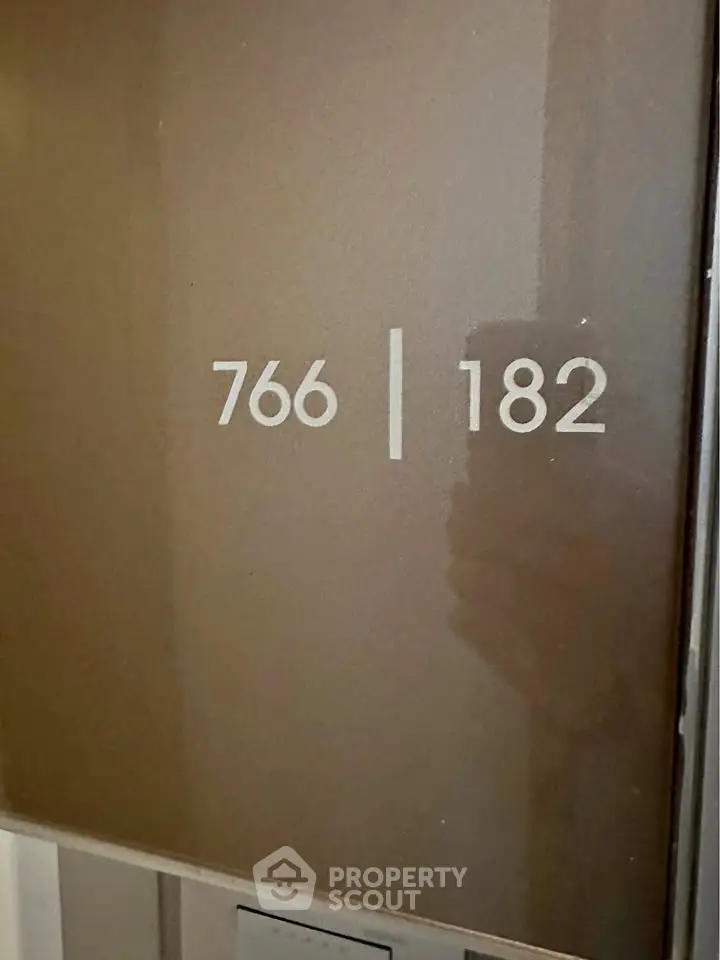 Modern apartment door with unit numbers 766 and 182, sleek design.