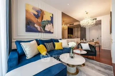 Luxurious living room with elegant decor and plush blue sofa in modern apartment.