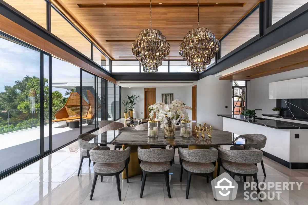 Luxurious open-plan living space with elegant dining set, modern kitchen, and panoramic windows offering lush views.