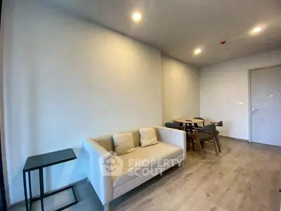 Modern living room with cozy sofa and dining area, perfect for relaxation and entertaining.