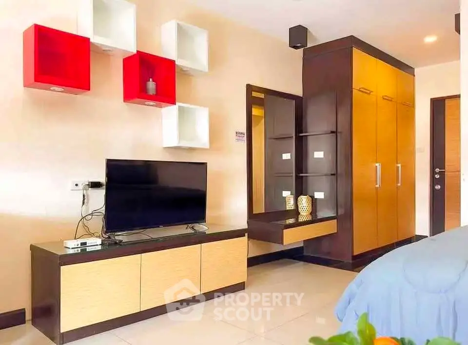 Modern living room with stylish TV unit and vibrant wall shelves